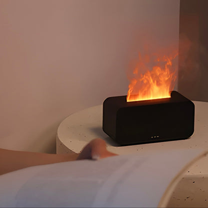 Modern black fireplace-simulator diffuser and humidifier with LED-flames on a white bedside table